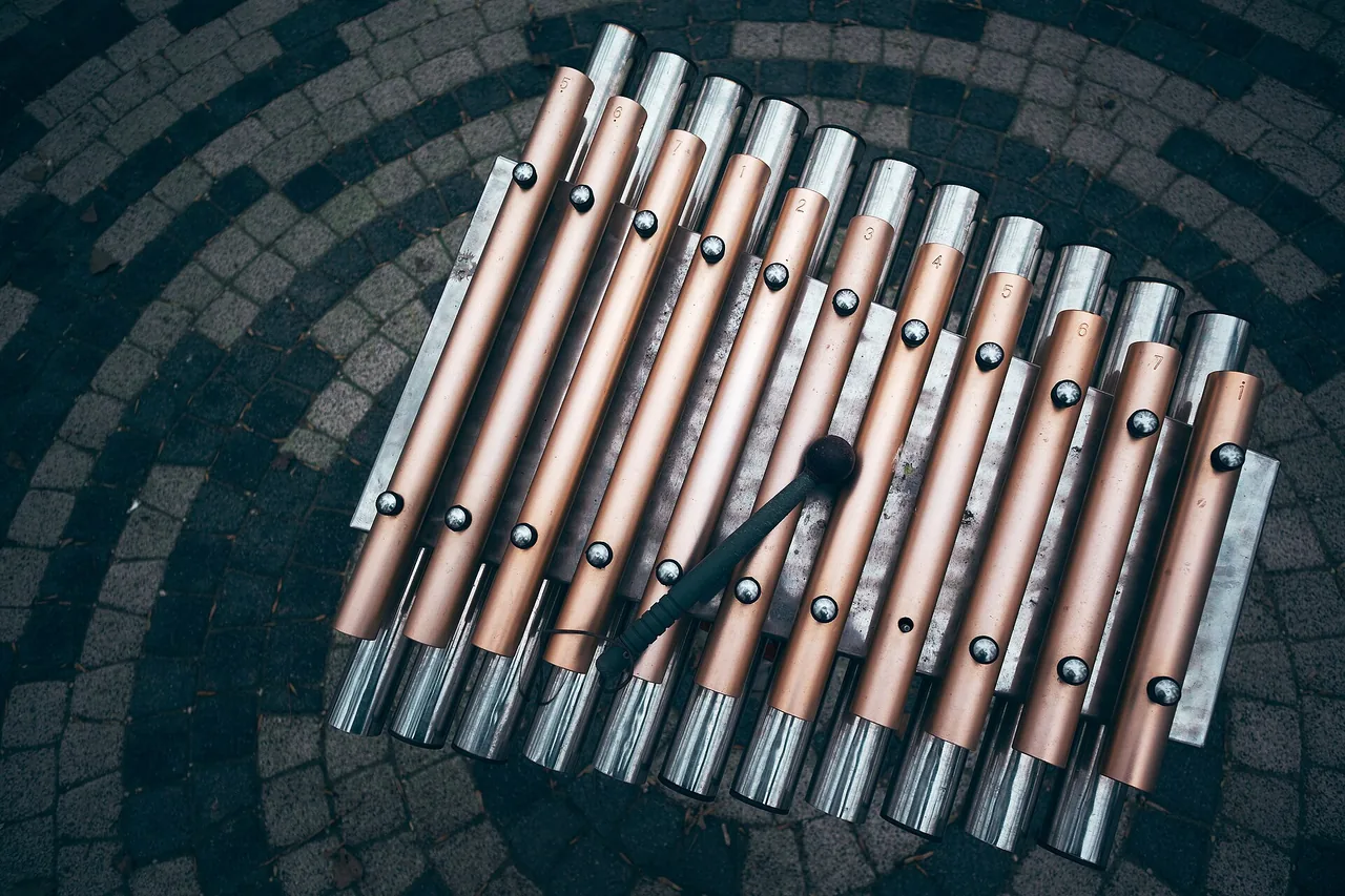 A colourful xylophone seen from above, mallets resting on the bars.